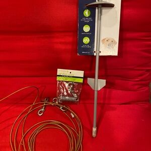 Set up for dog. Includes stake, spring and cord.